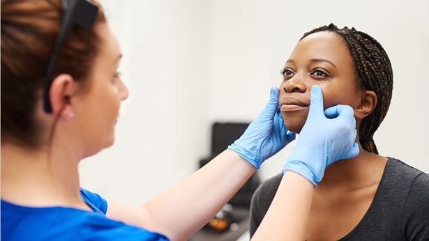 A woman being examined by a doctor